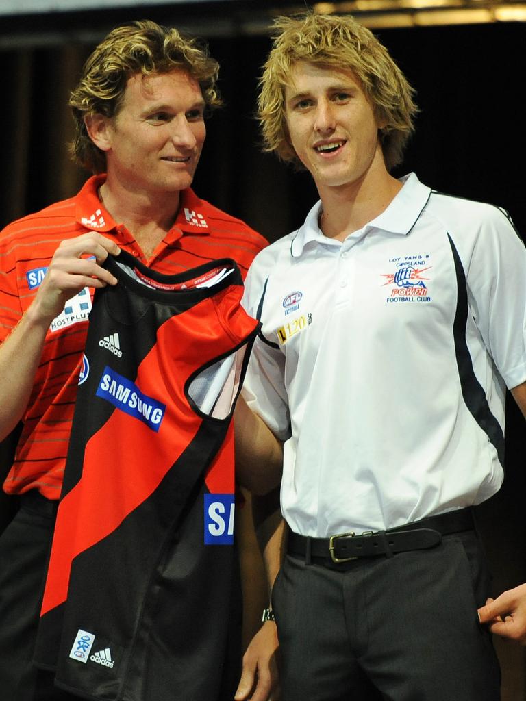 Then Essendon coach James Hird hands Dyson Heppell his jumped after being drafted to the club.