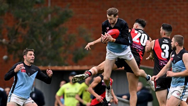 Aberfeldie’s Tim Currie flies in to take a mark in front of Pascoe Vale’s Dan Guccione. Picture: Andy Brownbill