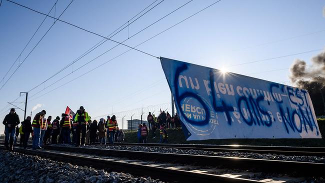 French protesters with a sign reading “64 years old, it’s no”. Picture: Loic Venance/AFP