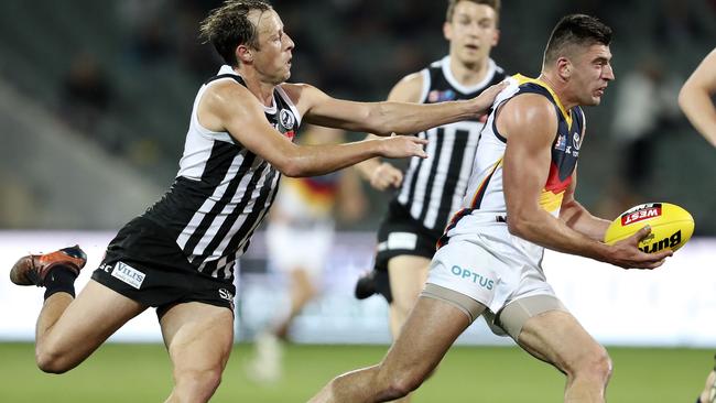 Port’s Cam Sutcliffe tackles Crow Patrick Wilson in last week’s qualifying final. Picture: SARAH REED