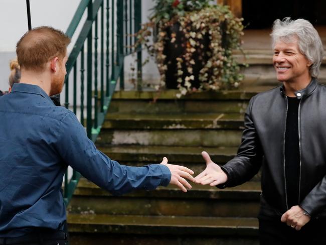 Britain's Prince Harry, Duke of Sussex (L) meets US singer Jon Bon Jovi as he arrives at Abbey Road Studios in London. Picture: AFP