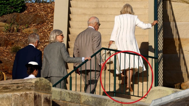 His Majesty King Charles III and Her Majesty Queen Camilla taking her shoes off as they return to Admiralty House. Picture: Jonathan Ng