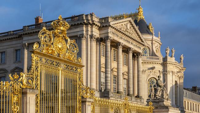 Fragment of golden entrance gates to the Versailles Palace in Paris.