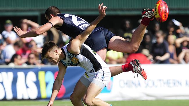 Melbourne's Colin Garland flies high over Port Adelaide's Robbie Gray at Traeger Park. Picture: Justin Brierty