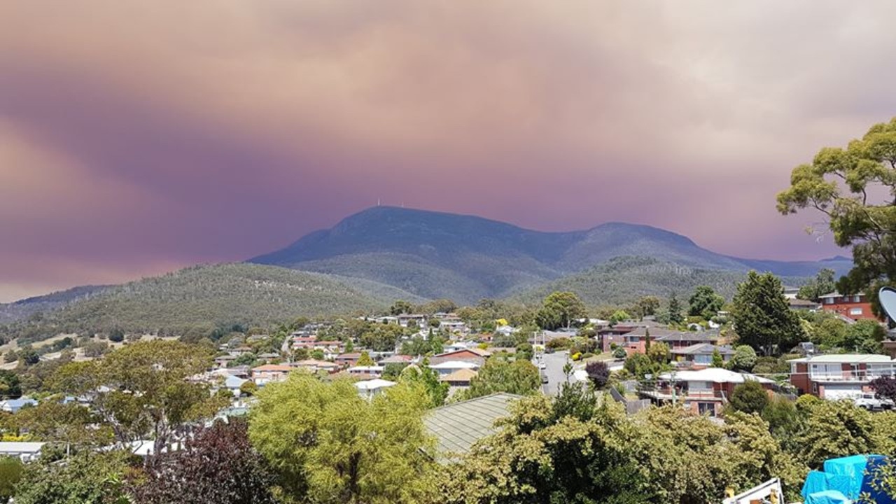 A darkened sky over kunanyi/Mt Wellington from smoke from an uncontrolled bushfire raging in the state’s South West. Picture: NICK DONNELLY