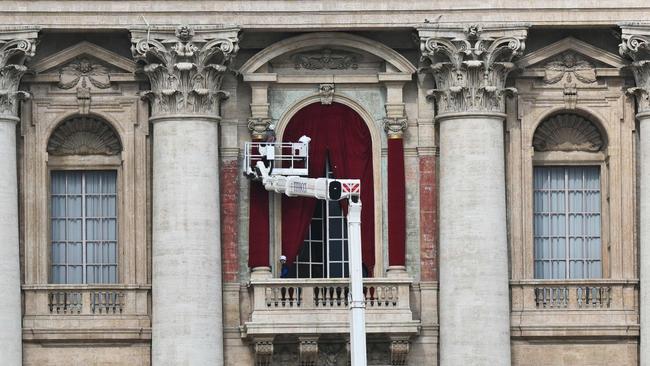 A worker operates on a crane for preparations of the main central loggia balcony of the St Peter's Basilica where the name of the new pope will be announced. Picture: Alberto Pizzoli/AFP