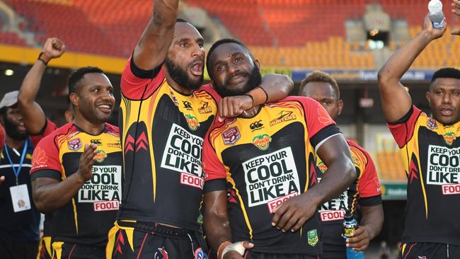 PNG Hunters players celebrate the historic win.