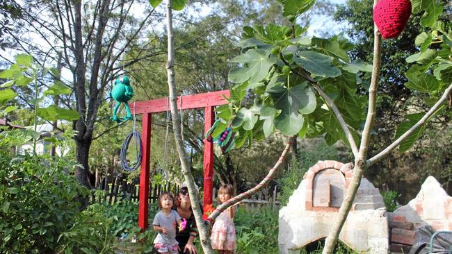 GROWING MOVEMENT: Max Burgess (centre) with her son Juno and neighbour Kahula Dangerfirld at the Little Keen St community garden.