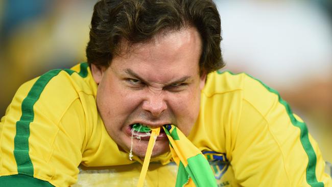 A Brazil fan can hardly contain himself as they win the anthems hands down.