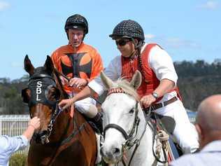 TREBLE TIME: Jockey Jim Byrne is led into the Ipswich enclosure aboard Tough One, the first of his three wins last Friday. Picture: Rob Williams