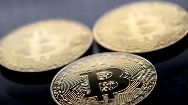 Gold-plated souvenir Bitcoin coins arranged for a photograph in London. (Image: AFP/Justin Tallis)