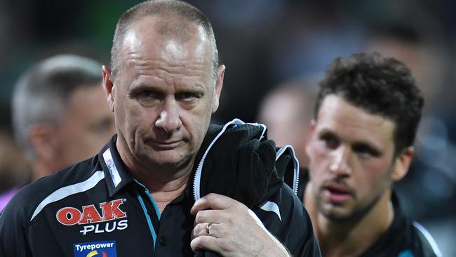 Power coach Ken Hinkley and captain Travis Boak leave Adelaide Oval after Saturday night’s 34-point loss to Geelong. Picture: Julian Smith (AAP).