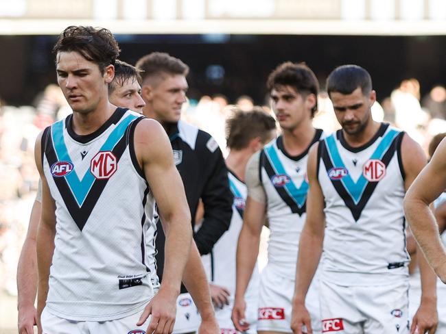 MELBOURNE, AUSTRALIA - APRIL 20: Port Adelaide leave the field looking dejected after a loss during the 2024 AFL Round 06 match between the Collingwood Magpies and the Port Adelaide Power at the Melbourne Cricket Ground on April 20, 2024 in Melbourne, Australia. (Photo by Dylan Burns/AFL Photos via Getty Images)