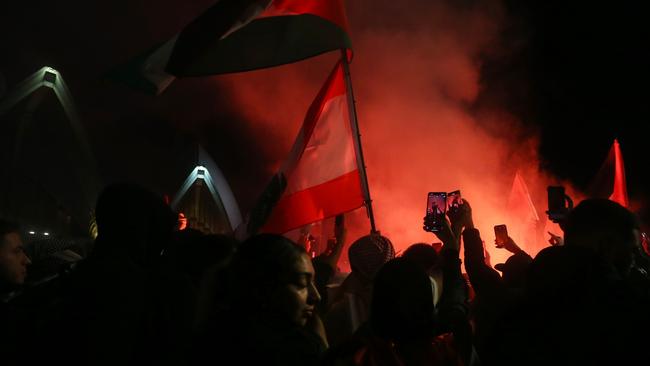 Palestine supporters ignite flares during a rally outside the Sydney Opera House on October 9. Picture: Getty Images