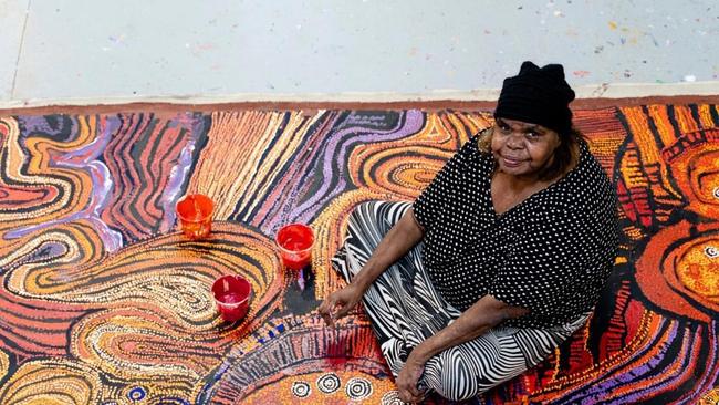 Nyunmiti Burton of the APY arts Centre Collective, with one of one of her artworks in progress. Photo: Supplied