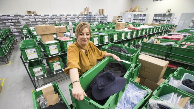 State Schools Relief chief executive Sue Karzis pictured last year with containers of school clothing. The not-for-profit has shifted funds to supply laptops and internet dongles, as the need for devices has skyrocketed with coronavirus remote learning. Picture: Norm Oorloff