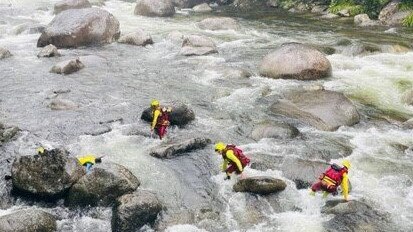 Members of the Cairns Queensland Fire and Emergency Services Swiftwater Unit braved treacherous conditions in the multi-agency search for a woman who went missing after being swept away at Mossman Gorge in Far North Queensland. Picture: Supplied