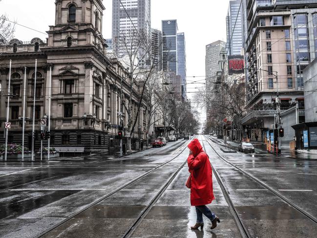 A woman crosses Collins Street in Melbourne’s CBD as the state of Victoria continues a five-day lockdown. Picture : NCA NewsWire / Ian Currie