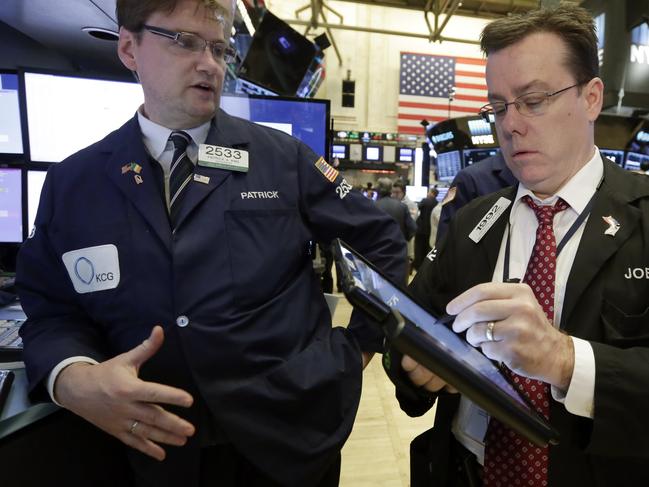 Specialist Peter King, left, and trader Joseph Murray work on the floor of the New York Stock Exchange, Monday, March 28, 2016. Stocks are edging mostly higher in the early going. Markets are generally quiet with trading closed across Europe for the Easter holiday. (AP Photo/Richard Drew)