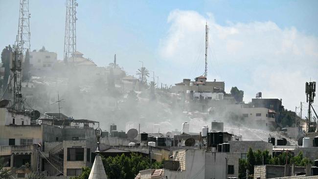 Smoke rises above buildings during an Israeli army raid in Jenin in the occupied-West Bank on August 31. Picture: AFP