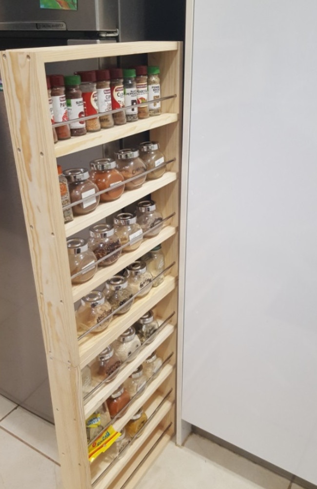 She noticed a large gap between her fridge and cupboard and decided to buy two spice racks from Bunnings. She screwed one on top of the other and just slid it in the space. Picture: Facebook/BunningsMums