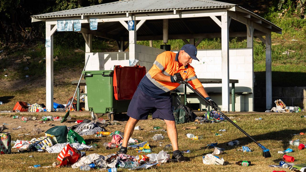 Clean-up crews get to work on the mountains of trash left behind after over 10,000 people celebrated Christmas Day at Bronte Beach. Picture: Tom Parrish