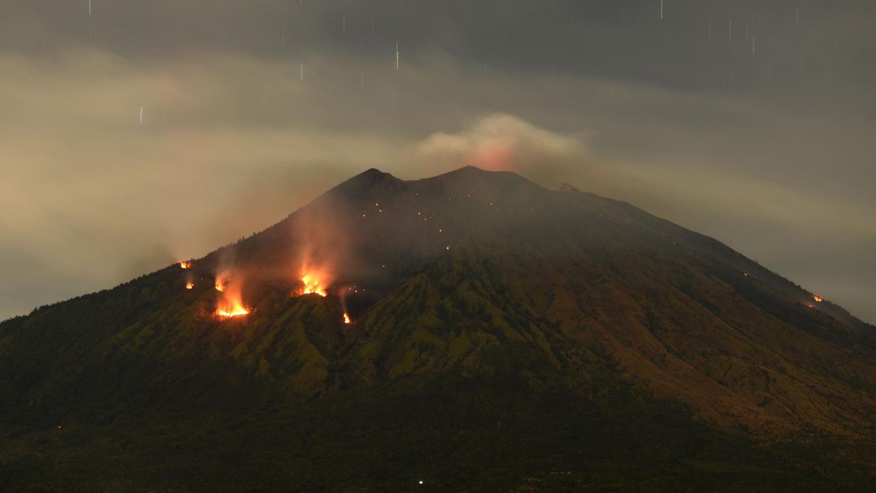 Trees burn on the slopes of Mount Agung after it erupted on July 3, 2018. Sonny Tumbelaka