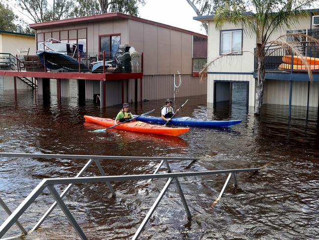 Allie Brinkworth and Stephen Hawsler kayak around flooded properties at Morgan. Photo: Calum Robertson