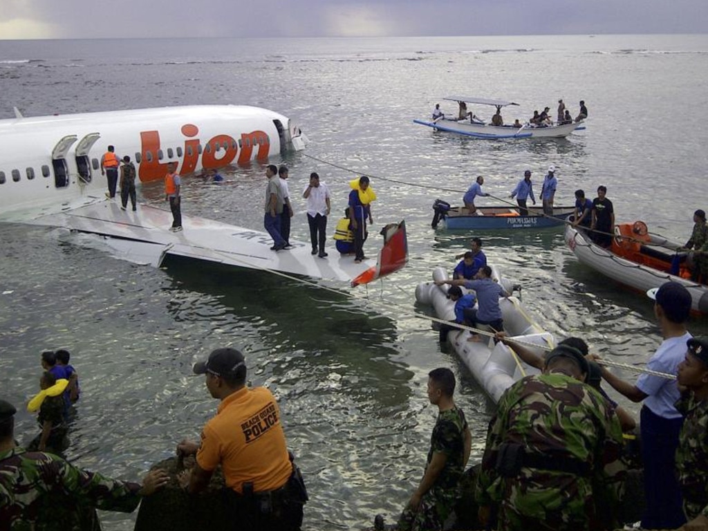 Rescuers at the crash site of a Lion Air plane that overshot the runway in Bali on April 13, 2013. Picture: National Rescue Team