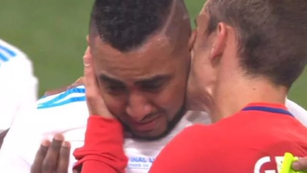 Dimitri Payet is consoled by Antoine Griezmann after his injury.