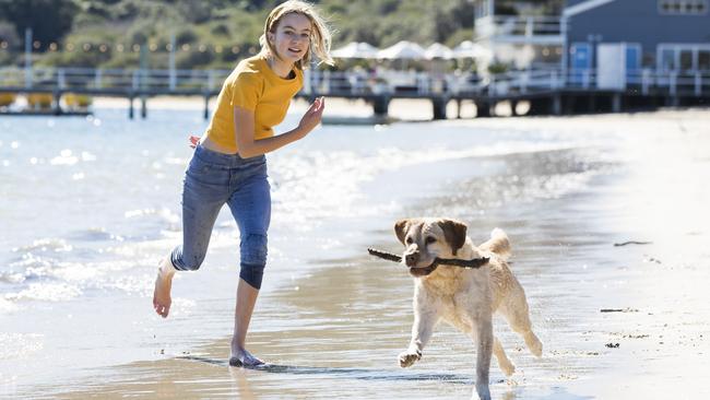 Caitlin Harbot, 11, with Myffy the Labrador at Station Beach, on Pittwater at Palm Beach, during an off-leash trial in 2019. Supporters were hoping it would become a permanent off-leash dog area. Picture: Dylan Robinson