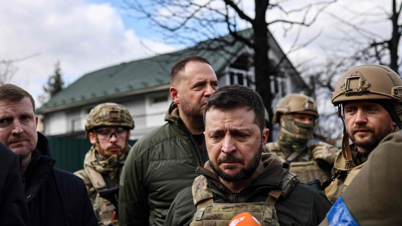 Ukainian President Volodymyr Zelensky (C) speaks to the press in the town of Bucha, northwest of the Ukrainian capital Kyiv, on April 4. Picture: RONALDO SCHEMIDT / AFP