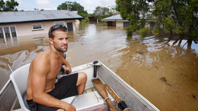 Barry Adams of Woodend used this dingy to help his family move possessions and themselves to higher ground on Leslie Street at East Ipswich. Picture: David Nielsen