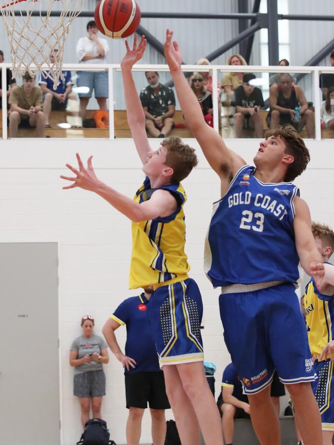 Basketball Queensland Under-16 Boys State Championships at the Coomera Indoor Sports Centre. Gold Coast Rollers (blue) v Townsville Heat Division 1 game . Rollers Nikos Karathanasopoulos (23) and Heats Jack Abbott (8) Picture Glenn Hampson