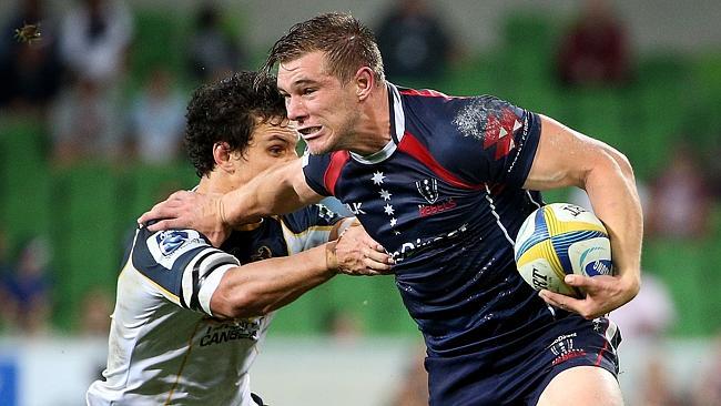 Melbourne Rebels v. ACT Brumbies at AAMI Park , Jason Woodward pushes off Matt Toomua. March 28th 2014 . Picture: Colleen Petch.