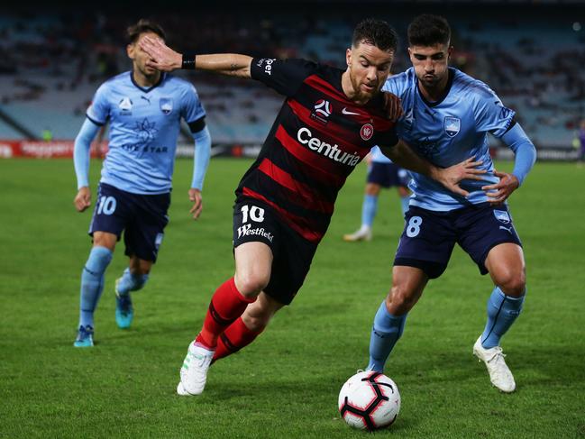 SYDNEY, AUSTRALIA - APRIL 13: Alexander Baumjohann of the Wanderers is challenged by Paulo Retre of Sydney FC during the round 25 A-League match between the Western Sydney Wanderers and Sydney FC at ANZ Stadium on April 13, 2019 in Sydney, Australia. (Photo by Matt King/Getty Images)