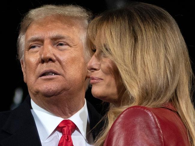 US President Donald Trump leaves the stage with First Lady Melania Trump at the end of a rally to support Republican Senate candidates at Valdosta Regional Airport in Valdosta, Georgia on December 5, 2020. - President Donald Trump ventures out of Washington on Saturday for his first political appearance since his election defeat to Joe Biden, campaigning in Georgia where two run-off races will decide the fate of the US Senate. (Photo by ANDREW CABALLERO-REYNOLDS / AFP)