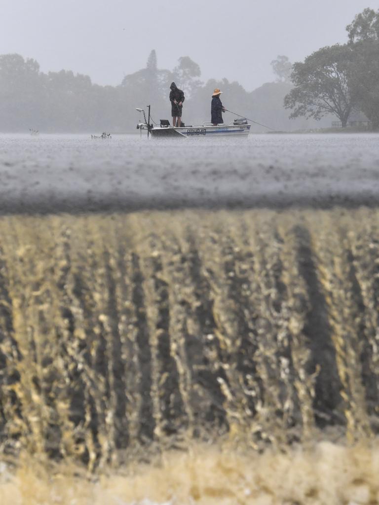 Wet weather in Townsville. Heavy rain does not stop fishing at Applins Weir. Picture: Evan Morgan