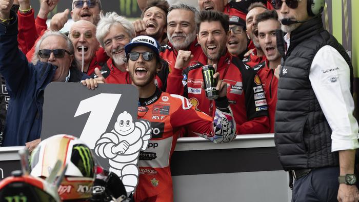 NORTHAMPTON, ENGLAND - AUGUST 04:  Enea Bastianini of Italy and Ducati Lenovo Team celebrates the victory with team under the podium during the MotoGP race during the MotoGP Of Great Britain - Race at Silverstone Circuit on August 04, 2024 in Northampton, England. (Photo by Mirco Lazzari gp/Getty Images)