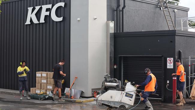 Workmen on the job at KFC Nerang, which will reopen on February 21. Picture Glenn Hampson