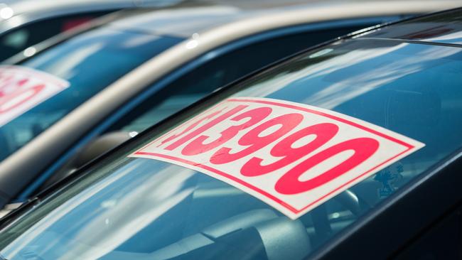 Generic image of vehicle with splash price tag in used car yard.