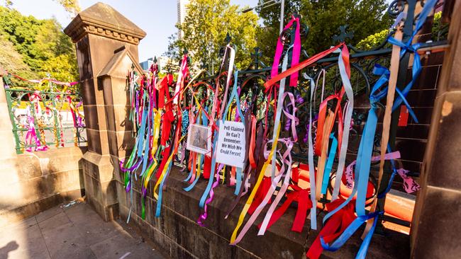 A silent protest took place on Wednesday, with dozens of people tying ribbon to the fence of the church ahead of the service. Picture: NCA NewsWire / Ben Symons