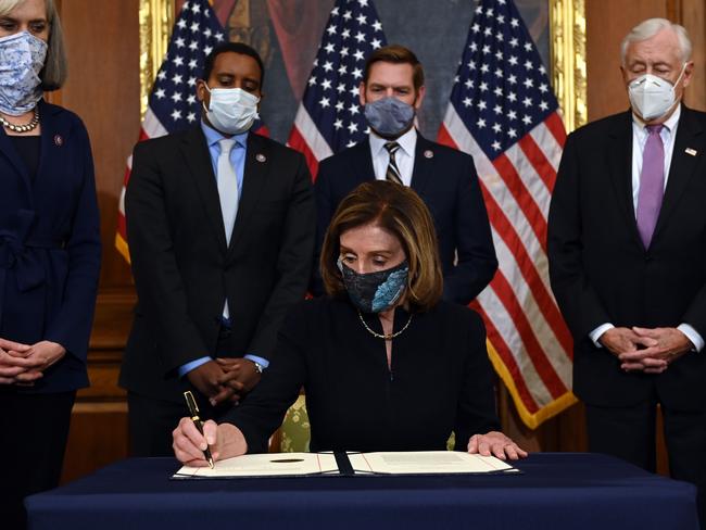 Speaker of the House Nancy Pelosi, signs the article of impeachment during an engrossment ceremony after the US House of Representatives voted to impeach the US President Donald Trump. Picture: AFP