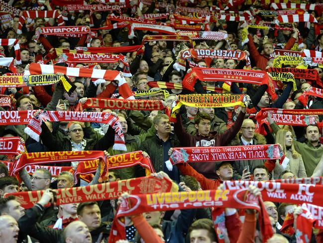 Liverpool fans raise scarves and sing before the UEFA Europa league quarter-final second leg football match between Liverpool  and Borussia Dortmund at Anfield stadium in Liverpool on April 14, 2016. / AFP PHOTO / OLI SCARFF