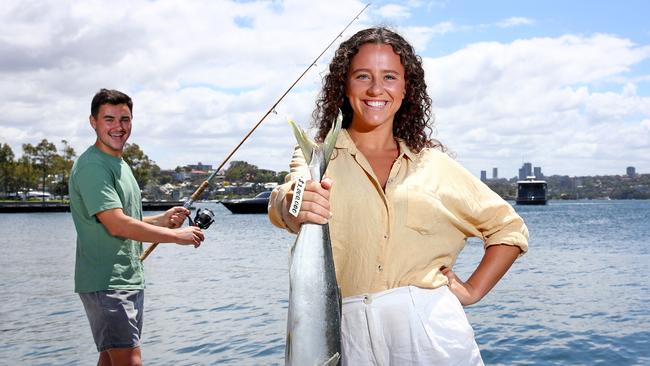 Ben Buckland and Nicola Muddle hold a Kingfish like the one that will be tagged and released in Sydney Harbour as part of the million dollar fish promotion. Picture: Toby Zerna