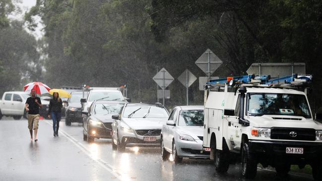 Vehicles are stopped by police on Tallebudgera Connection Road at the back of Currumbin Creek after torrential rain overnight caused the creek to break its banks. NCA NewsWire / Scott Powick
