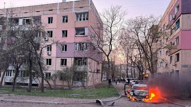 A burning car next to damaged buildings in Kryvyi Rig, after a reported missile strike amid the Russian invasion on Ukraine. Picture: Telegram / @V_Zelensky_official / AFP