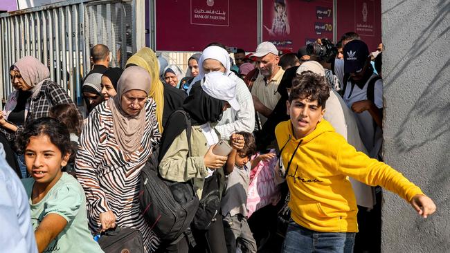 A group of Australians trapped in Gaza escaped the enclave following the brief reopening of the Rafah crossing to Egypt. (Photo by Mohammed ABED / AFP)