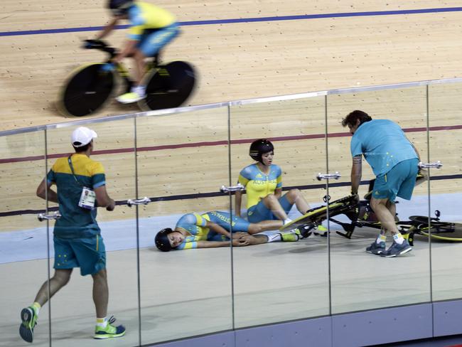 Melissa Hoskins, center left, of the Australian women's track cycling team, reacts after crashing during a training session inside the Rio Olympic Velodrome during the 2016 Olympic Games in Rio de Janeiro, Brazil, Monday, Aug. 8, 2016.