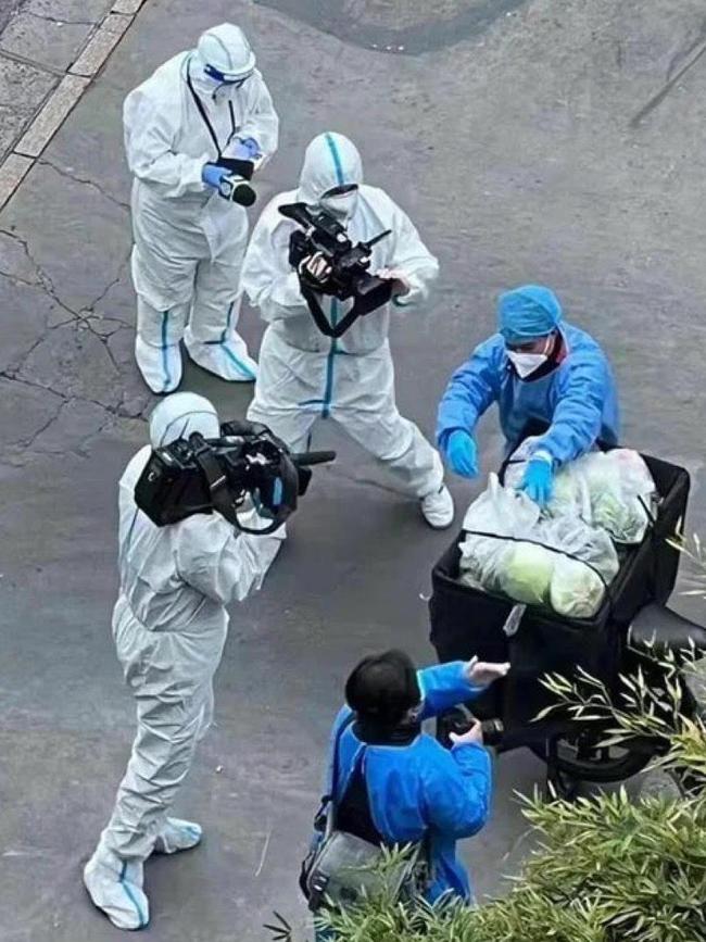 Chinese propaganda workers in Shanghai filming a story about serving the people vegetables.